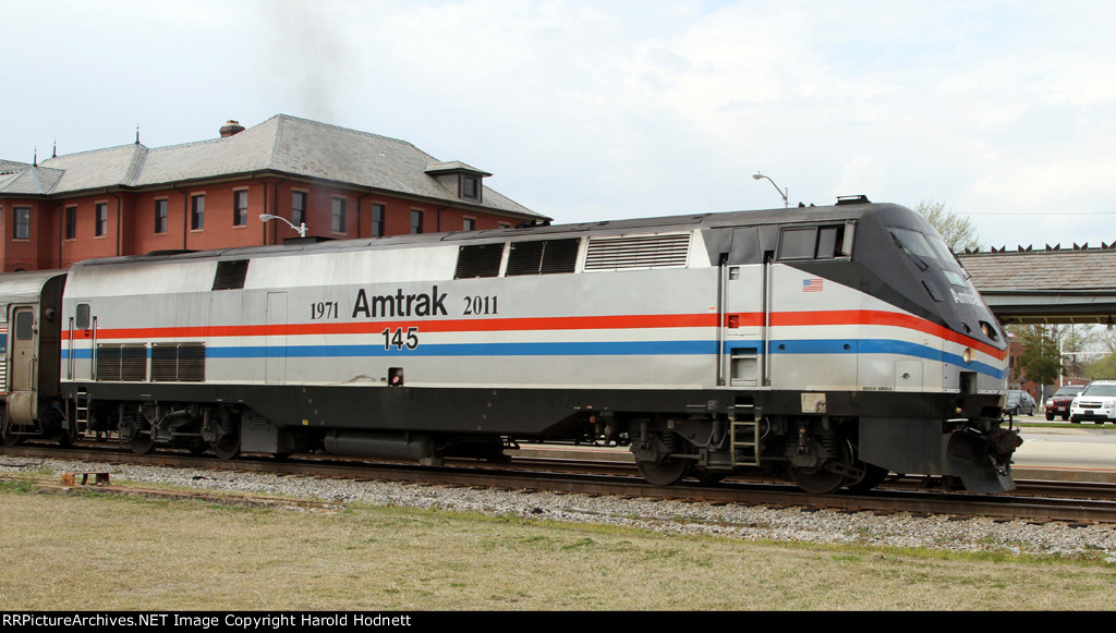 AMTK 145 leads train P080 away from the station